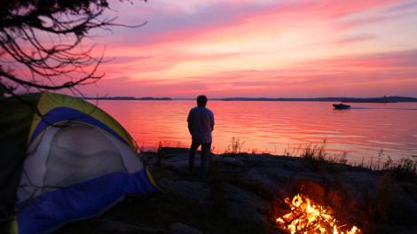 Taking in the tranquil sunset from a secluded waterfront campsite