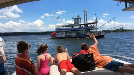 Waving to passengers aboard the Chautauqua Belle paddleboat cruise on Chautauqua Lake