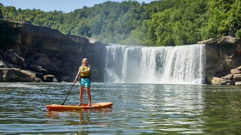 A stand-up paddle boarding tour alongside thundering Cumberland Falls