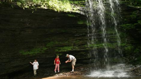 Searching for stones beneath a cascading waterfall in Pennsylvania