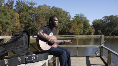 Cedric Burnside taking a break from fishing to play guitar in Jackson, Mississippi Cedric Burnside taking a break from fishing to play guitar in Jackson, Mississippi