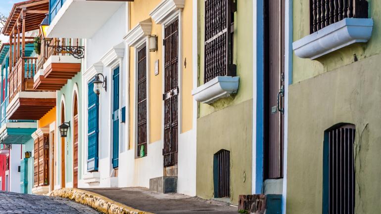 Colonial architecture and colorful buildings line the street