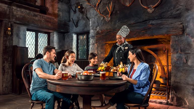 Family dining at the Three Broomsticks™ in The Wizarding World of Harry Potter™