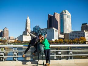 Posing with a deer sculpture in front of the city skyline on the Scioto Mile Posing with a deer sculpture in front of the city skyline on the Scioto Mile
