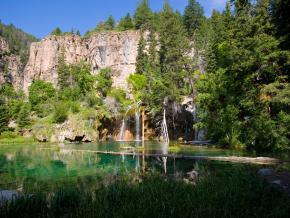 Waterfalls cascading over cliffs at Hanging Lake, a National Natural Landmark Waterfalls cascading over cliffs at Hanging Lake, a National Natural Landmark