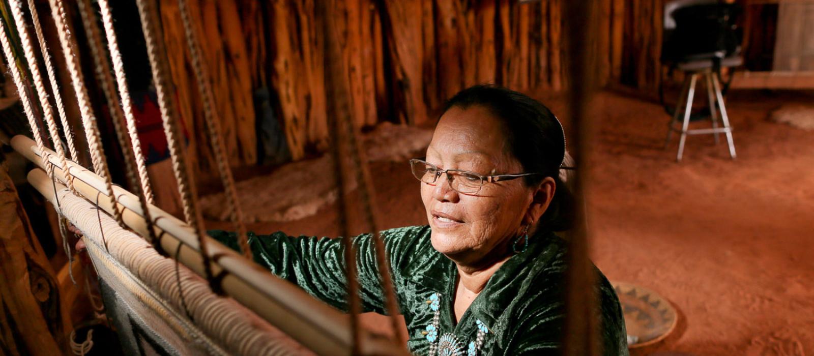 A Navajo woman working on a traditional loom near Monument Valley, Utah