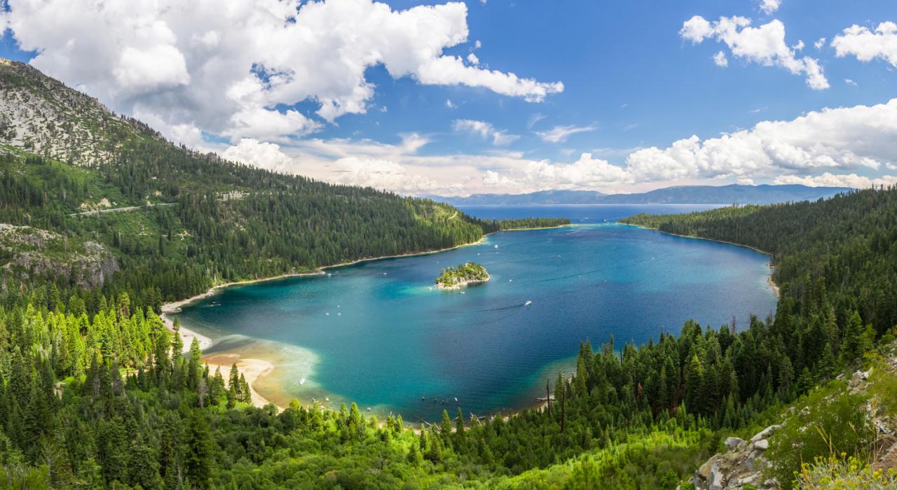 An alpine forest surrounds the aquamarine waters of Lake Tahoe 
