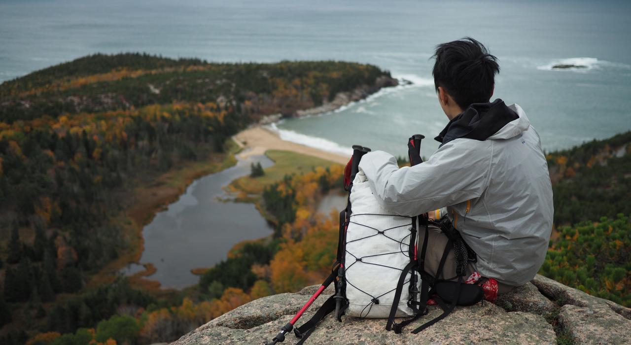 Hiker taking in the view at Acadia National Park, Maine