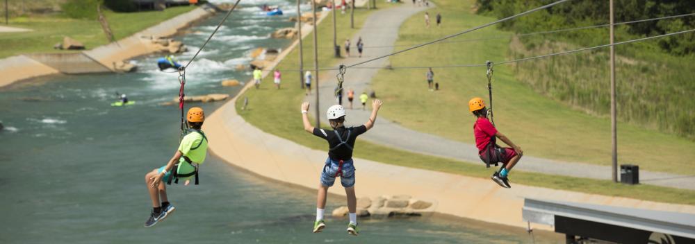 Zip lining with views of the rapids at the U.S. National Whitewater Center in Charlotte, North Carolina Zip lining with views of the rapids at the U.S. National Whitewater Center in Charlotte, North Carolina